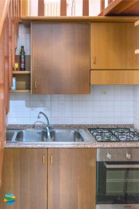 a kitchen with a sink and a stove at Casamare in Amalfi