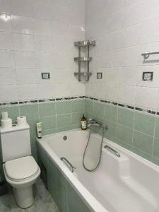 a bathroom with a toilet and a bath tub with at Bajka centar in Bosanska Gradiška +17 photos