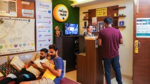 a group of men sitting in a waiting room at AmigosIndia in New Delhi