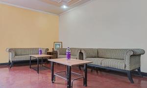 two tables with purple vases on them in a room at Itsy By Treebo - Ranjeet in Kolhapur