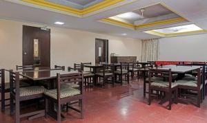 a dining room with tables and chairs in it at Itsy By Treebo - Ranjeet in Kolhapur