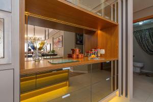 a kitchen with a counter with glass doors at Glamour - Stay House Temporada in Gramado