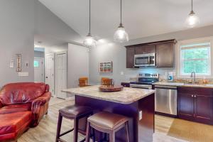 a kitchen with a bar and a couch in it at Brown Moose Acres in Bridgton