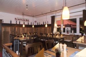 a dining room with wooden tables and chairs at Echinger Hof bei München in Eching