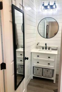 a bathroom with a sink and a mirror at The Bobcat Cabin - The Cabins at Rim Rock in Austin