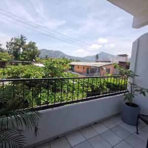 a balcony with a fence and plants on it at 1 BR APT with AC , TV , wi-fi near DT and beach in Zihuatanejo