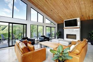 a living room with two couches and a fireplace at Blanc 24 - Les Chalets Alpins, Stoneham in Stoneham