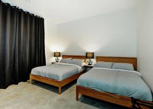 two beds sitting next to each other in a bedroom at Blanc 24 - Les Chalets Alpins, Stoneham in Stoneham