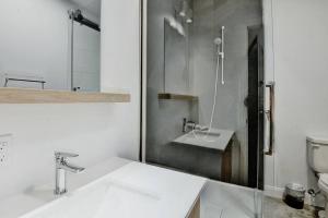 a white bathroom with a sink and a toilet at Blanc 24 - Les Chalets Alpins, Stoneham in Stoneham +48 photos