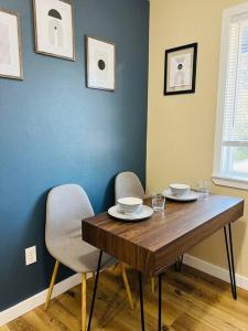a dining room table with two chairs and a blue wall at Mad Men in Salem