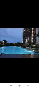 a view of a swimming pool in a city at night at Precious Angel Apartment Sky House BSD in Pagedangan