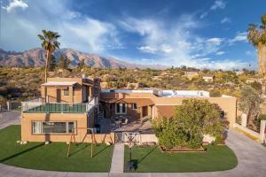an aerial view of a house with palm trees at Hill Top - Scenic Villa W Panoramic Views & Pool in Tucson