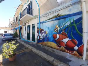a mural of a fish on the side of a building at La Casetta sul Mare in Isola delle Femmine