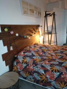 a bedroom with a bed with a colorful comforter at Appartement Cosy in Ault