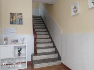 a stairway in a home with a white wall at Vivienda turística Ramón Trillo en Muxía in Muxia