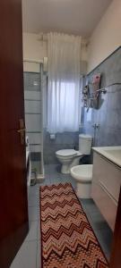 bagno con 2 servizi igienici e un tappeto di CASA SOFIA Via Amerigo Vespucci n18 a Roccalumera