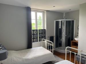 a bathroom with a shower and a large refrigerator at Le Relais D'Aulnay in Aulnay