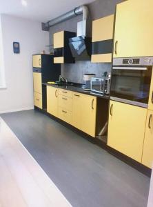 a kitchen with yellow cabinets and a stove top oven at Princess marfil in Biel