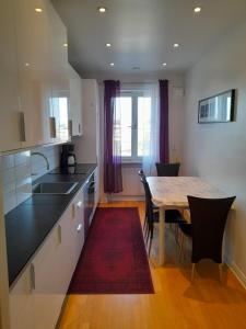 a kitchen with a table and a dining room at City Apartment2 in Gothenburg