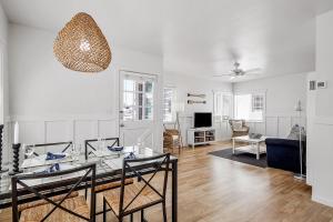 a living room with a table and a couch at Newport Coastal Comfort in Newport Beach