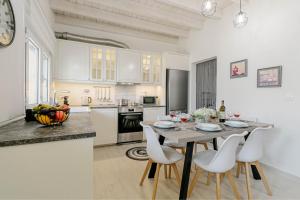 a kitchen with a table and chairs in a room at S&K Luxury Μaisonette in Potamós