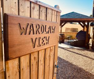 a wooden fence with a sign that reads warrior vista at 'Wardlaw View' Luxury studio apartment with stunning view in Kirkhill