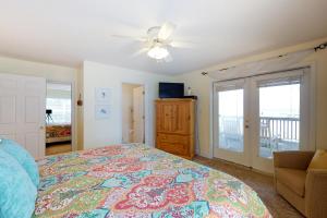 a bedroom with a bed and a ceiling fan at Footprints In The Sand in St. George Island