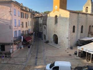 an alley in an old building with a white car parked at le calme à Salernes in Salernes