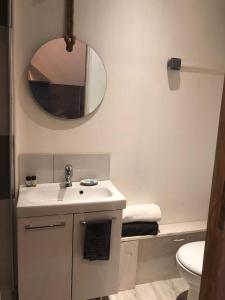 a white bathroom with a sink and a mirror at le calme à Salernes in Salernes