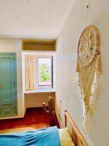 a room with a bed and a fan on the wall at Golden Wave Surf Villa in Corralejo