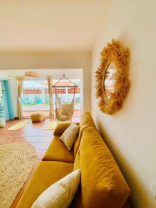 a living room with a couch and a mirror at Golden Wave Surf Villa in Corralejo