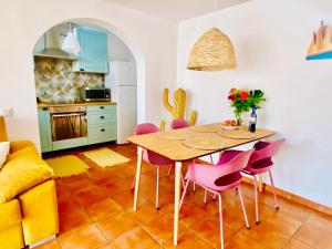 a kitchen and dining room with a table and chairs at Golden Wave Surf Villa in Corralejo