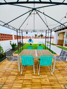 a table and chairs under an umbrella on a patio at Golden Wave Surf Villa in Corralejo