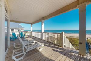 a porch with rocking chairs and the beach at See Escape in St. George Island