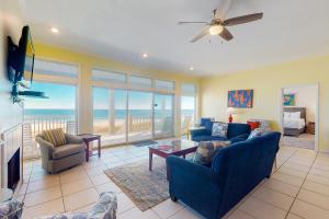 a living room with blue furniture and a view of the ocean at See Escape in St. George Island