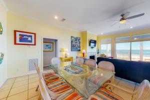 a living room with a glass table and chairs at See Escape in St. George Island