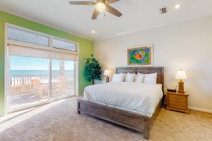a bedroom with a bed and a large window at See Escape in St. George Island
