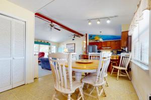 a kitchen and dining room with a table and chairs at Somerset in St. George Island