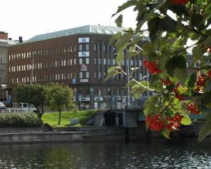 a building with a bridge over a body of water at Nattvikens Vandrarhem in Härnösand