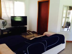 a living room with a couch and a tv at Dream Village Cumbuco Beach in Cumbuco