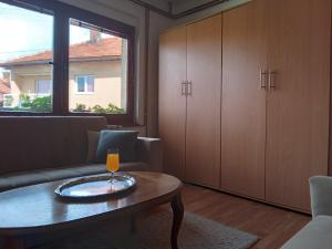 a living room with a couch and a coffee table at Apartmani Emir in Visoko