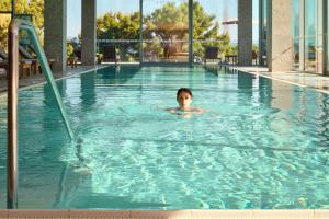 a woman swimming in a swimming pool at Radisson Blu Resort & Spa in Split