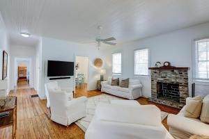 a living room with white furniture and a fireplace at Sullivan's Island Serenity in Sullivans Island