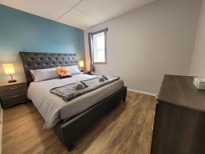 a bedroom with a large bed and a wooden floor at Beluga Beach House in Churchill
