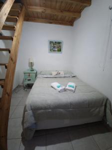 a bedroom with a bed and a wooden staircase at Río Tigris Apart 1 in Tigre