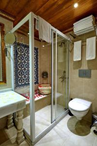 a bathroom with a shower and a toilet and a sink at Marmara Deluxe Hotel in Istanbul