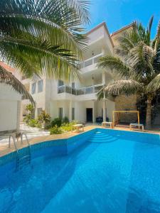 a large swimming pool in front of a building at Francesca Guest House in Dakar