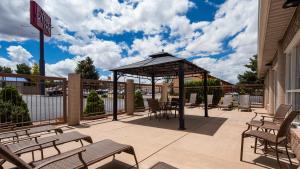 a gazebo with chairs and tables on a patio at Abbey Inn Cedar City in Cedar City
