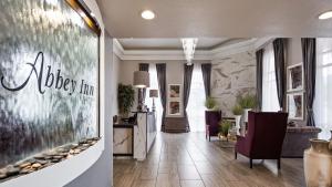 a living room with a fish tank on the wall at Abbey Inn Cedar City in Cedar City +36 photos