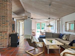 a living room with a couch and a table at 10 person holiday home in Dannemare-By Traum in Dannemare